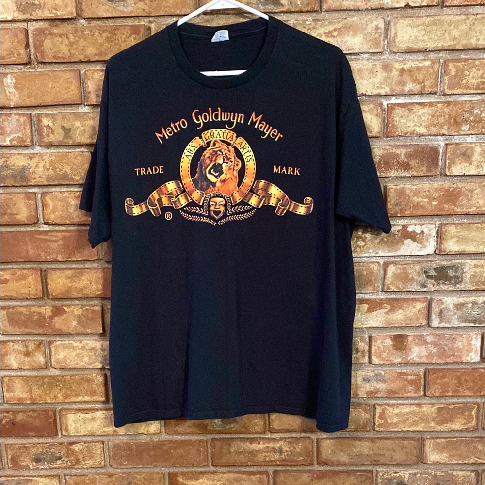 Port and Company Black and Gold Metro Goldwyn Mayer Trade Mark Short Sleeve Tee
